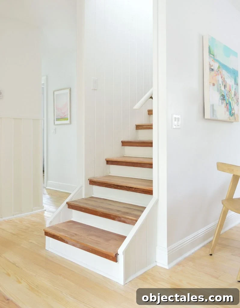 Bare wood stairs in white house