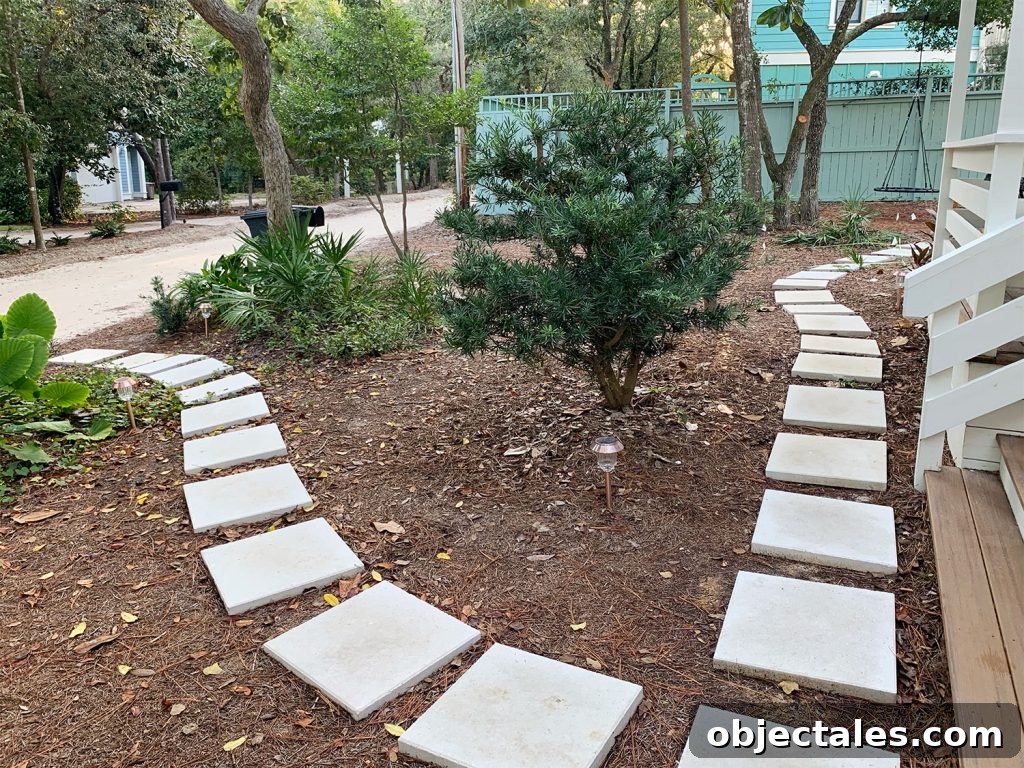 Square White Paver Pathway Around Mulched Front Yard