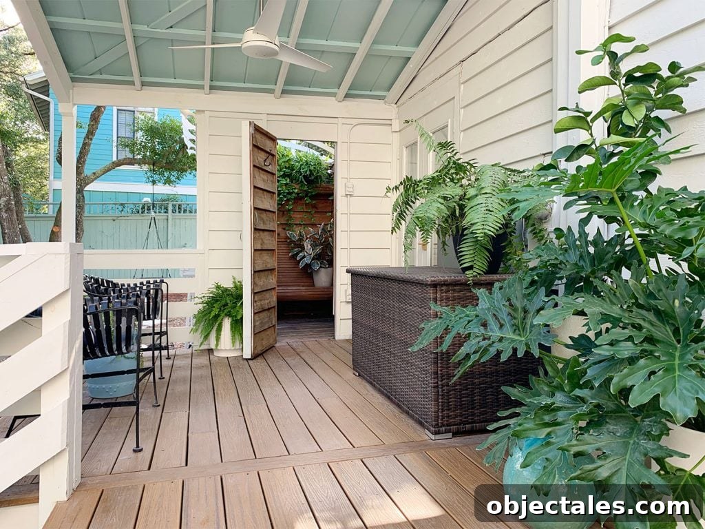 Covered Porch With Blue Ceiling And Open Door To Outdoor Shower
