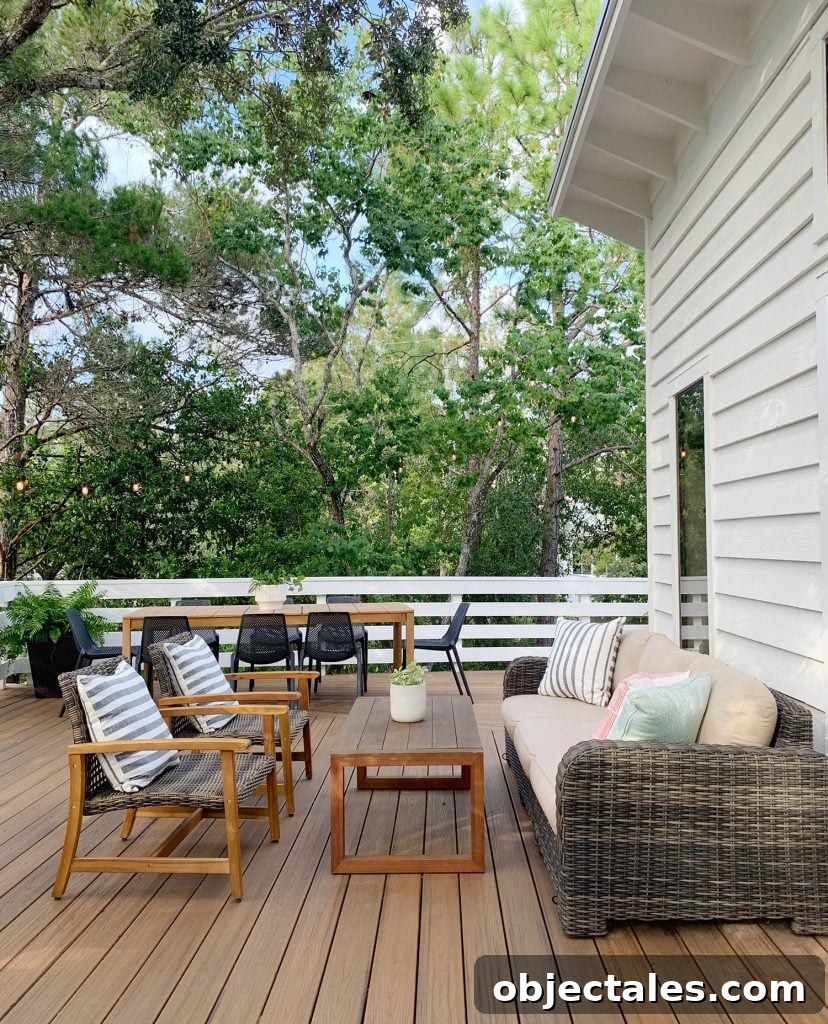Deck Seating Area With Outdoor Couch Table And Two Woven Lounge Chairs