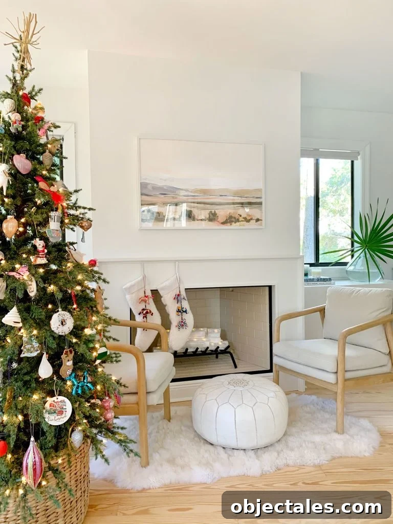 Christmas tree next to seating area in front of finished modern fireplace