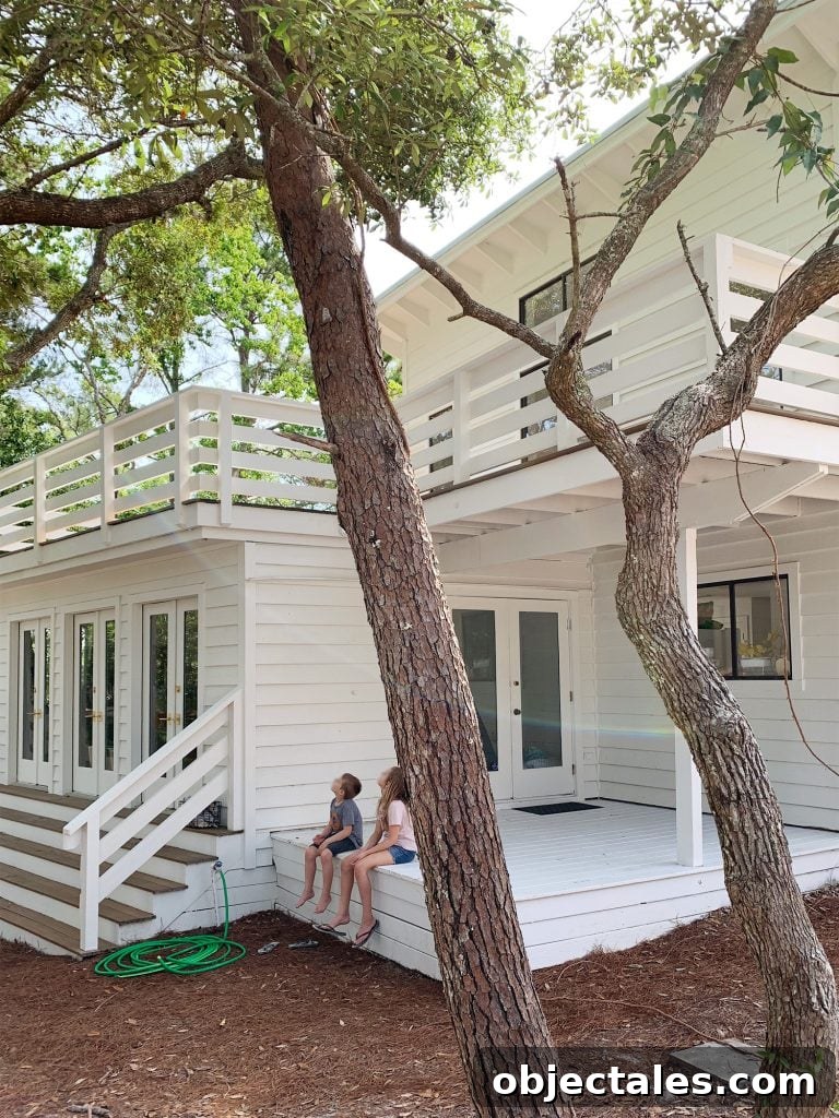 How to Paint a Porch Floor: Prep, Paint, and Finish 3 Covered white porch on move-in day with kids sitting on stoop