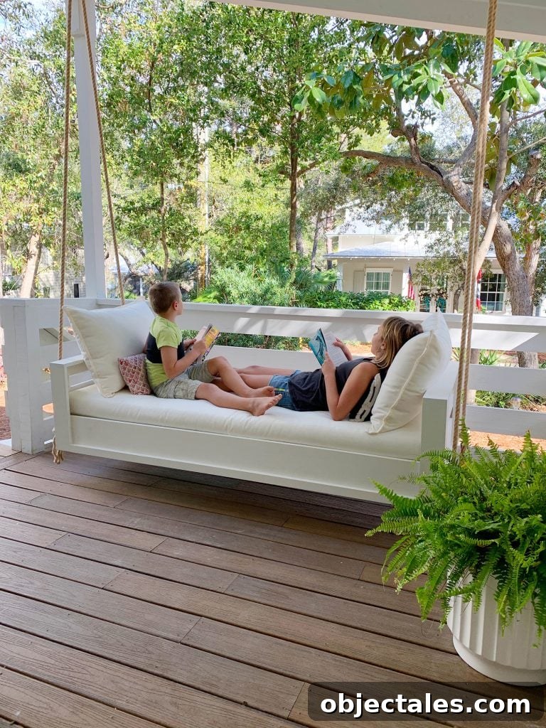 Build a Hanging Daybed: Step-by-Step DIY Tutorial 2 Two Kids Reading On Either End Of White Hanging Daybed Swing