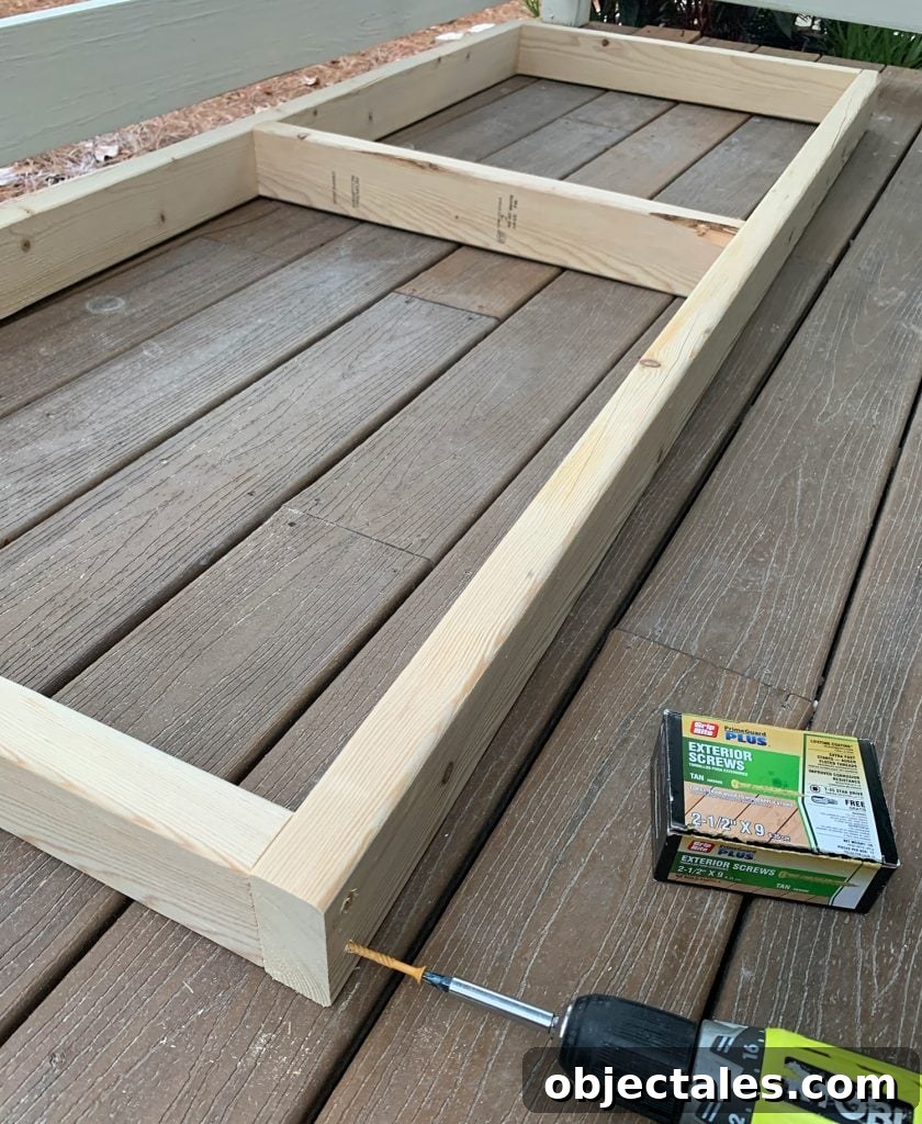 Build a Hanging Daybed: Step-by-Step DIY Tutorial 10 Screwing 2x4 wood frame together for hanging daybed