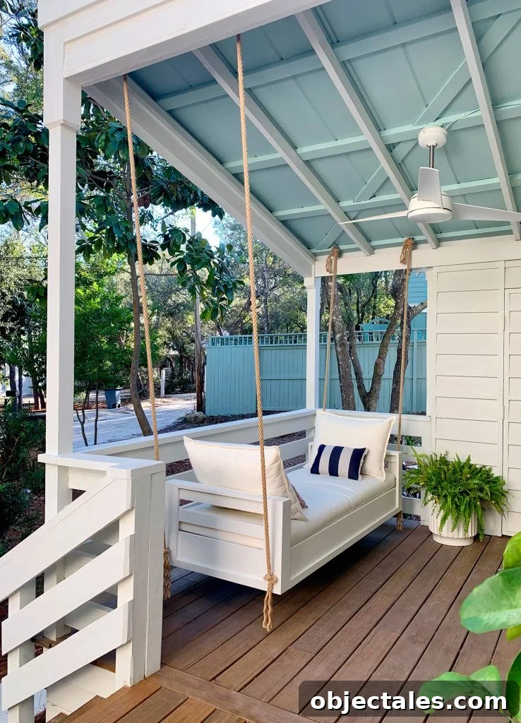 Outdoor Hanging Daybed Hung With Rope In Four Spots Under Covered Porch Ceiling