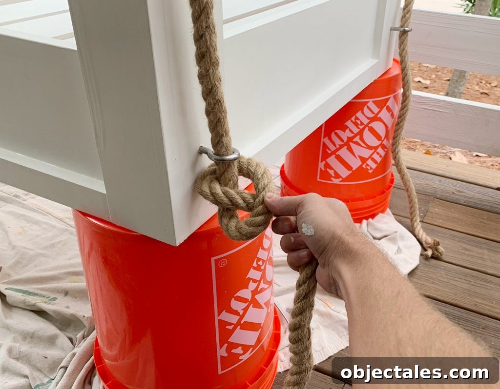 Typing pretzel knot on the bottom of hanging daybed under eyehook