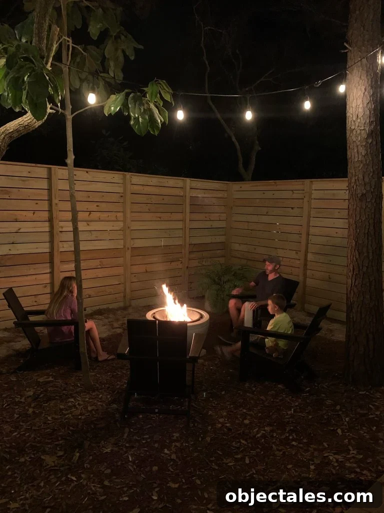 Create a Cozy Fire Pit Area for Outdoor Gatherings 3 Family sitting around fire pit with unpainted fence