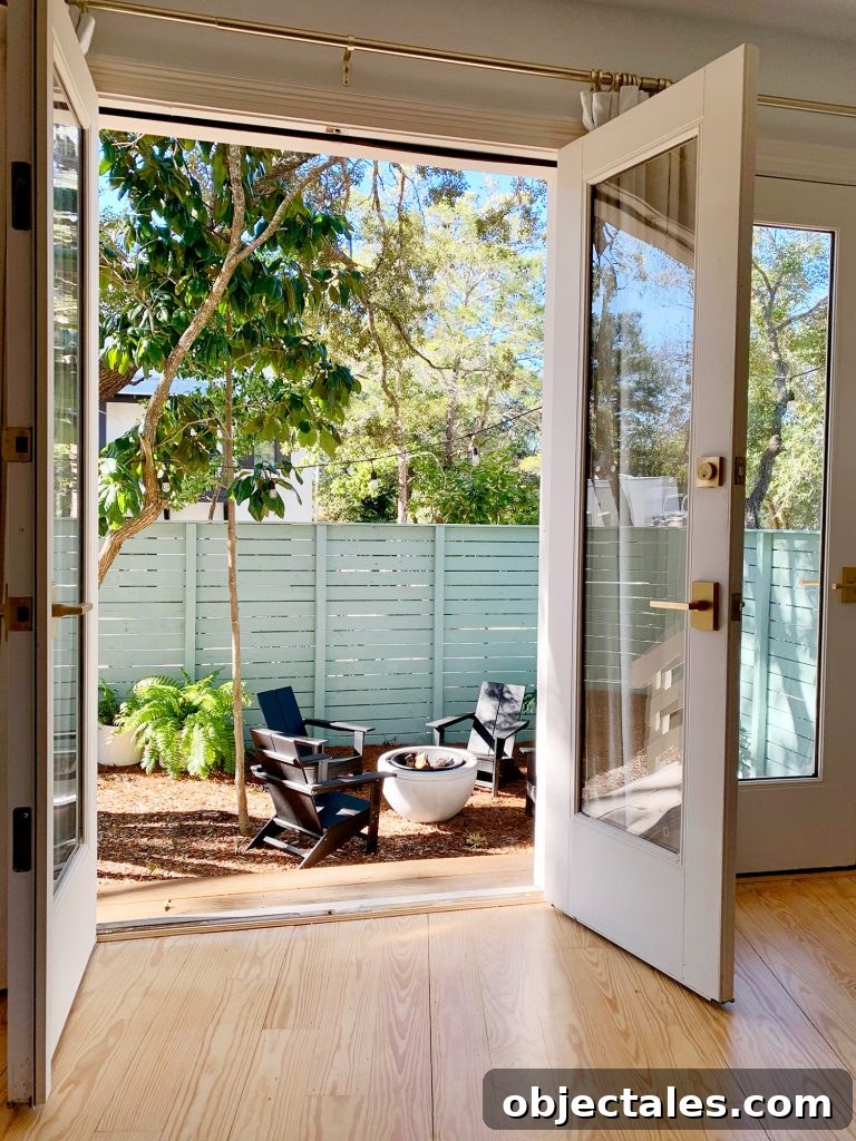 Create a Cozy Fire Pit Area for Outdoor Gatherings 5 View of fire pit area through open french doors in bedroom