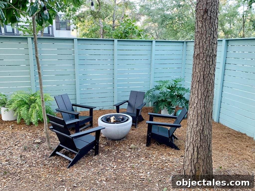 Create a Cozy Fire Pit Area for Outdoor Gatherings 7 Side yard with blue-green painted horizontal fence
