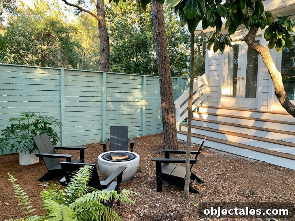 Create a Cozy Fire Pit Area for Outdoor Gatherings 8 Blue-green painted horizontal fence around side yard with long steps leading up to bedroom