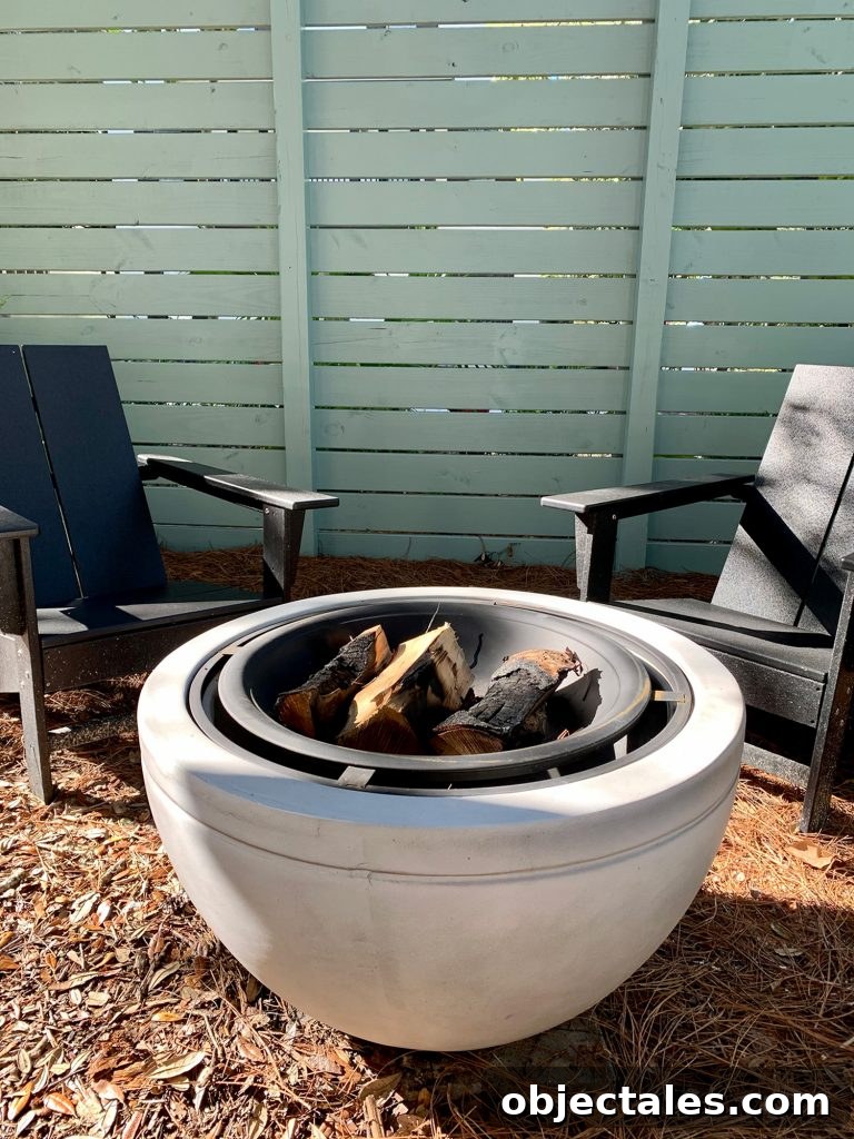 Create a Cozy Fire Pit Area for Outdoor Gatherings 9 Detail of faux stone fire pit with burnt logs in it