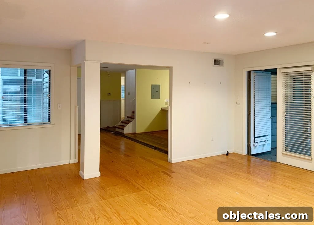 Before photo of bedroom with two openings to living and kitchen area