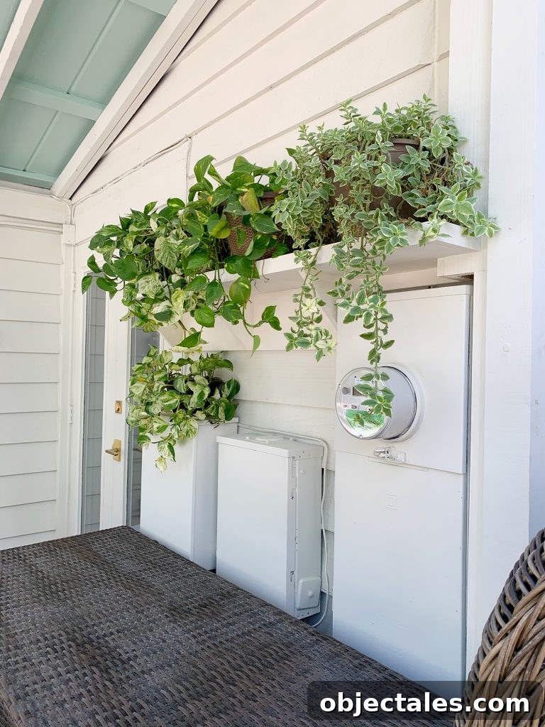 Hide Unsightly Utility Boxes with a DIY Shelf 6 Closer View Of Plant Shelf With Foliage Covering Electrical Panel Boxes Painted White