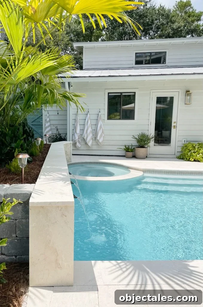 Gray stone retaining wall terminating into back of stone tile accent retaining wall