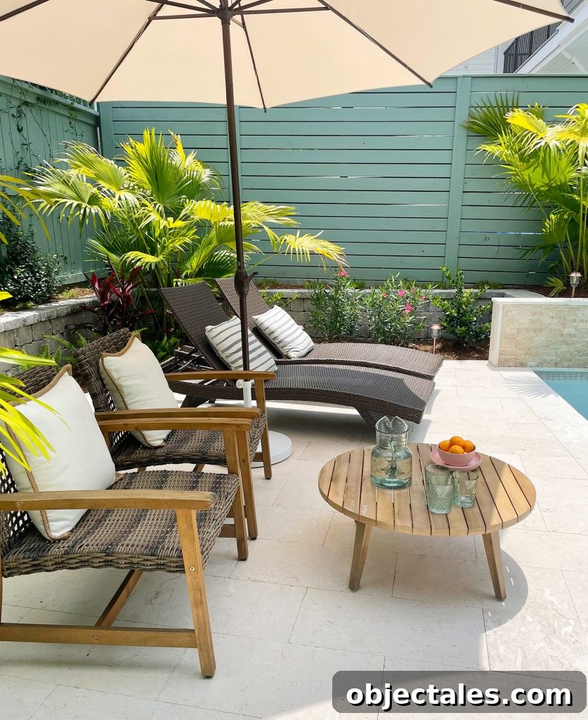 Sideview of seating area with umbrella lounge chairs and small coffee table