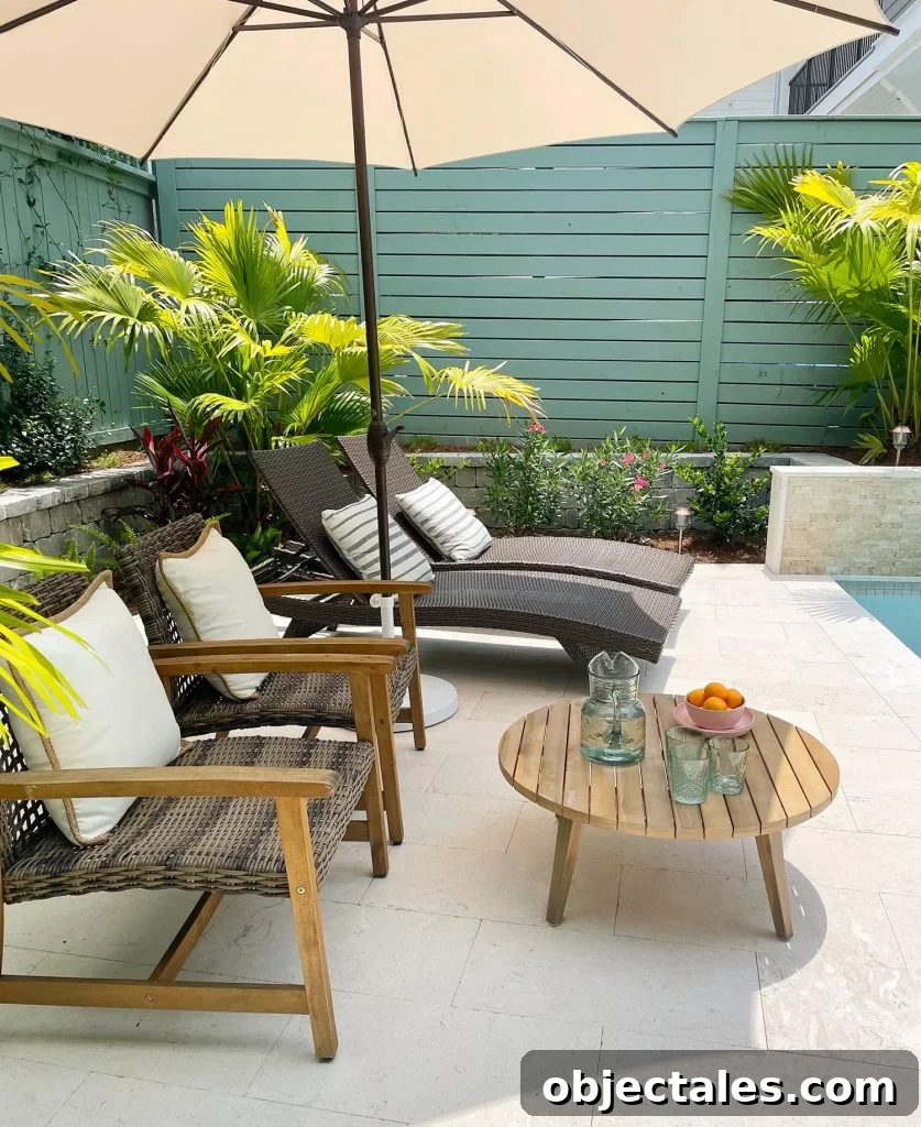 Sideview of seating area with umbrella lounge chairs and small coffee table