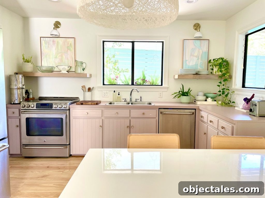 Straight View Of Beach Kitchen With Pink Mauve Cabinets And Floating Shelves