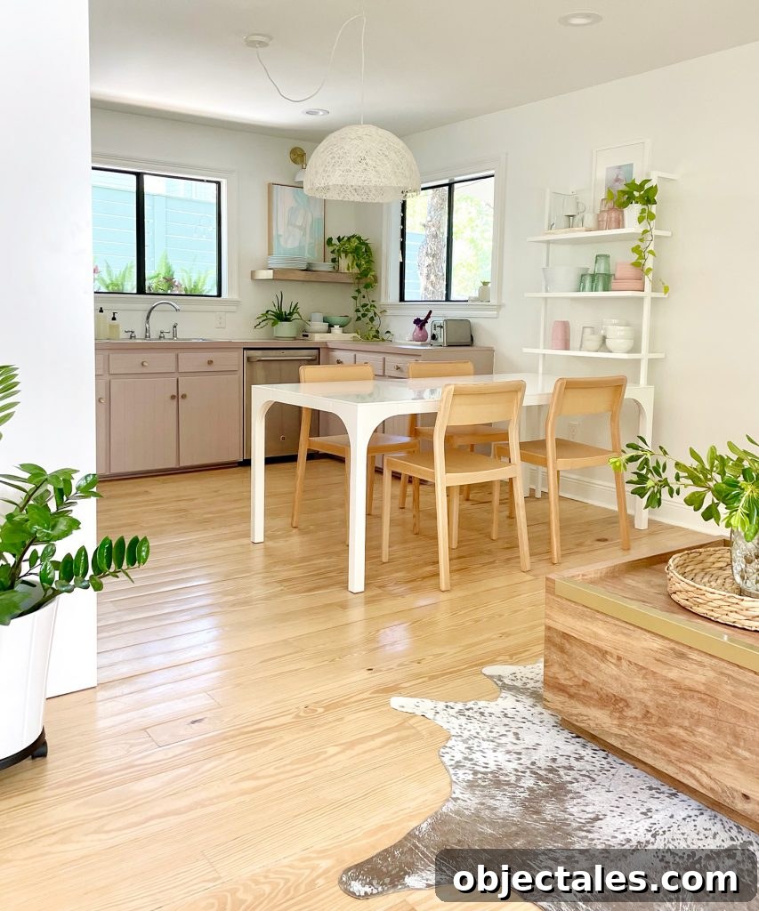 Vertical View Of Walking Space To Beachy Kitchen With Wood Furniture And Mauve Cabinets