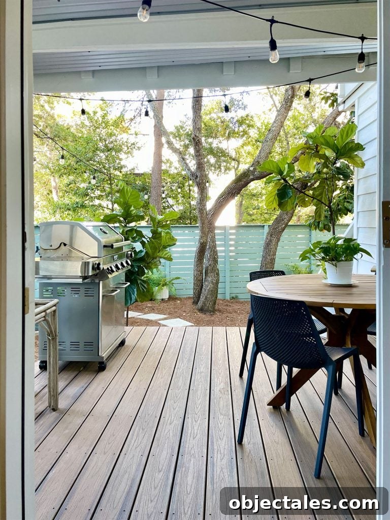 View through kitchen door of covered kitchen porch with table and grill