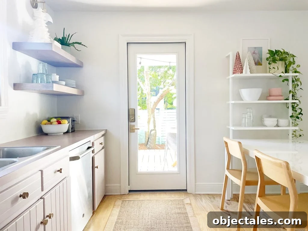 white kitchen with door out to patio